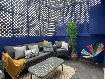 a living room with a couch and a chair at Un bijou d'élégance au coeur du quartier Racine de Casablanca in Casablanca