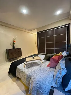a room with a bed with a table on it at Un bijou d'élégance au coeur du quartier Racine de Casablanca in Casablanca