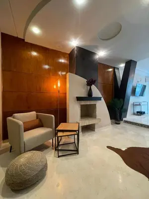 a living room with a couch and a fireplace at Un bijou d'élégance au coeur du quartier Racine de Casablanca in Casablanca