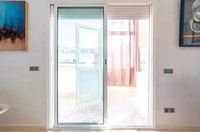 an open glass door in a room with a window at Spacieux appartement 80 m² - Centre de Casablanca in Casablanca