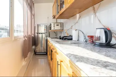 a kitchen with a sink and a refrigerator at Spacieux appartement 80 m² - Centre de Casablanca in Casablanca