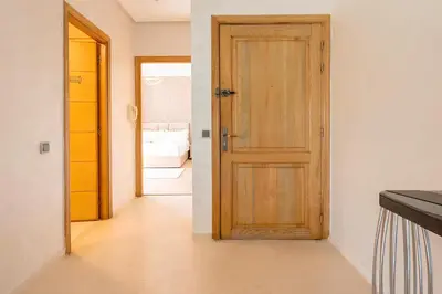 a room with a wooden door and a hallway at Spacieux appartement 80 m² - Centre de Casablanca in Casablanca
