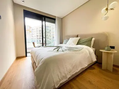 a bedroom with a bed with a large window at Modern Studio with Balcony & Parking Les Princesses 204 in Casablanca
