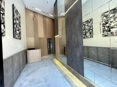 a hallway of a building with paintings on the walls at Modern Studio with Balcony & Parking Les Princesses 204 in Casablanca