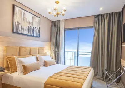 a bedroom with a large bed and a large window at Rent-inn Boutique Hotel in Rabat