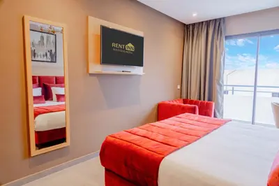 a hotel room with a bed and a tv at Rent-inn Boutique Hotel in Rabat