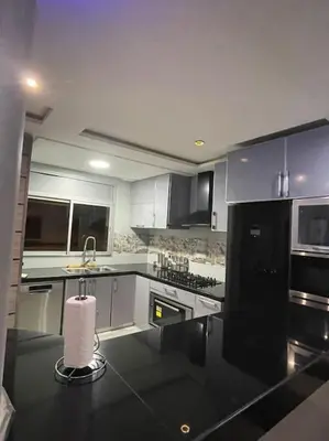 a kitchen with a black and white counter top at Appartement meublé à louer Rabat in Rabat