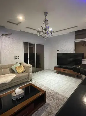 a living room with a couch and a television at Appartement meublé à louer Rabat in Rabat
