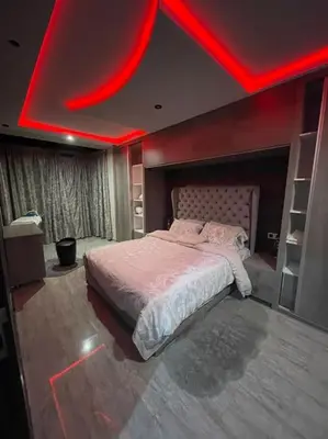 a bedroom with a large bed with a red ceiling at Appartement meublé à louer Rabat in Rabat