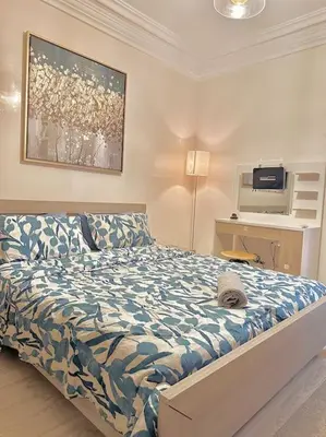 a bedroom with a bed and a painting on the wall at Lilias Appart - 2 Mars in Casablanca