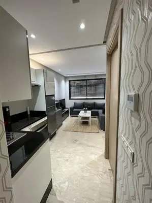 a room with a kitchen and a living room at Racine Studio bd Anfa in Casablanca