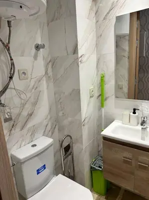 a bathroom with a white toilet and a sink at Racine Studio bd Anfa in Casablanca