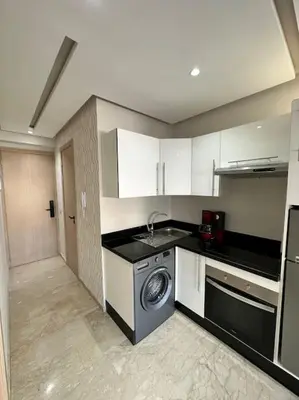 a kitchen with a sink and a dishwasher at Racine Studio bd Anfa in Casablanca