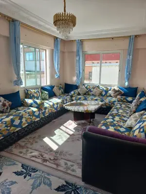 a living room with a couch and a table at Appartement moderne vue sur mer in Casablanca