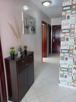 a hallway with a dresser and a door in a room at Appartement moderne vue sur mer in Casablanca
