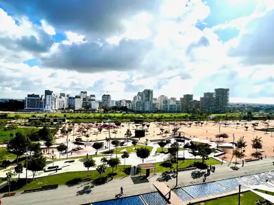 a view of a park with a city in the background at Anfa Finance City CFC! Magnifique Apt Tours Végétales, grande terrasse, piscine, parking in Casablanca