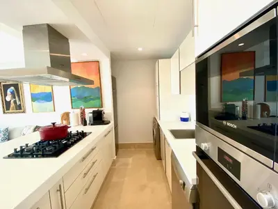 a kitchen with a stove and a sink at Anfa Finance City CFC! Magnifique Apt Tours Végétales, grande terrasse, piscine, parking in Casablanca