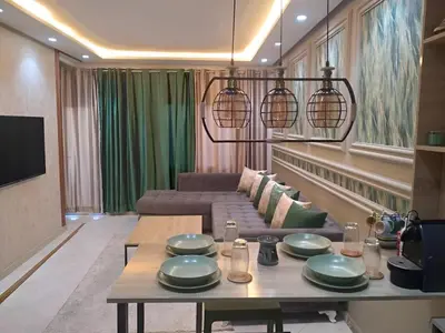 a living room with a table and a couch at Appartement joelle in Casablanca