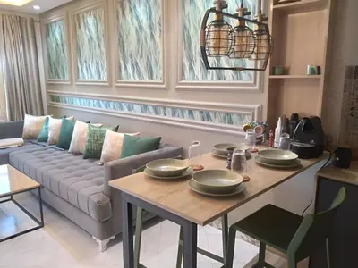 a living room with a table and a couch at Appartement joelle in Casablanca