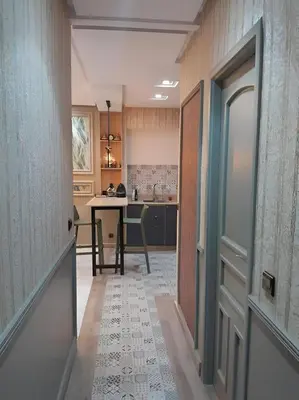 a hallway leading to a kitchen with a table in it at Appartement joelle in Casablanca