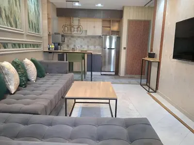 a living room with a couch and a table at Appartement joelle in Casablanca
