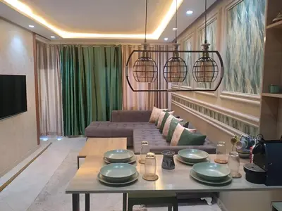 a living room with a table and a couch at Appartement joelle in Casablanca