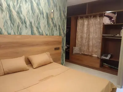 a bedroom with a bed and a painting on the wall at Appartement joelle in Casablanca