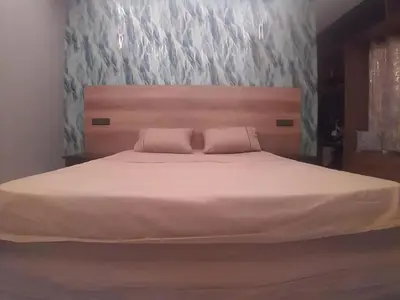 a bedroom with a large white bed with two pillows at Appartement joelle in Casablanca