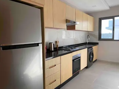 a kitchen with a stainless steel refrigerator and a stove at Luxueux Appart à 5 min aéroport mohamed 5 in Nouaceur