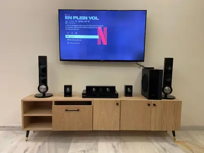 a flat screen tv on a wall above a wooden entertainment center at Luxueux Appart à 5 min aéroport mohamed 5 in Nouaceur