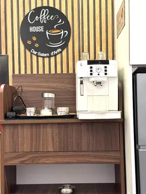 a coffee shop with a coffee house sign on a counter at Studio anfa plaza in Casablanca