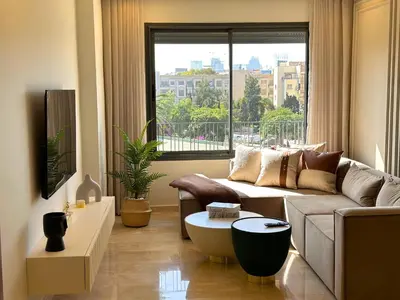 a living room with a couch and a large window at Luxueux studio, vue dégagée in Casablanca