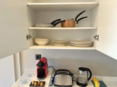 a kitchen with a counter top with dishes on shelves at Luxueux studio, vue dégagée in Casablanca