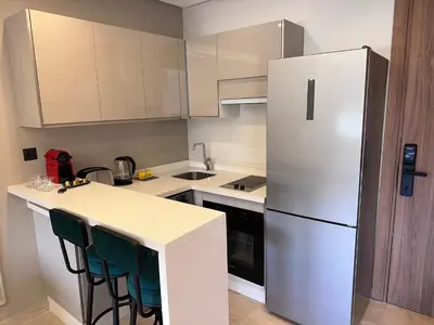 a kitchen with a white refrigerator and a counter at Luxueux studio, vue dégagée in Casablanca