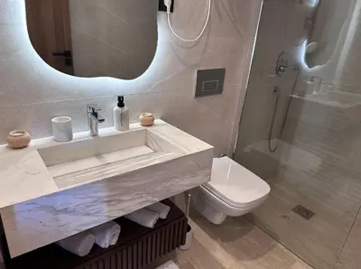 a bathroom with a sink and a toilet and a mirror at Luxueux studio, vue dégagée in Casablanca
