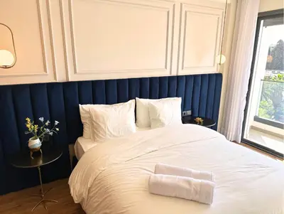 a bedroom with a white bed with a blue wall at Luxueux studio, vue dégagée in Casablanca