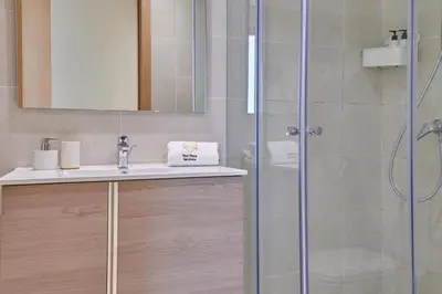 a bathroom with a sink and a shower at YourPlace Rabat - Royal Residence in Rabat