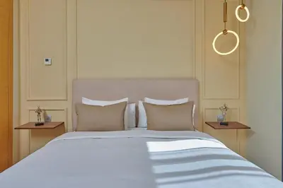 a bedroom with a large white bed with pillows at YourPlace Rabat - Royal Residence in Rabat