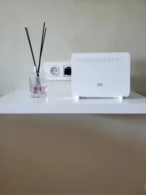 a white counter with a laptop and a vase with sticks at Le doux refuge - à 7 mn de la plage à pieds in Temara