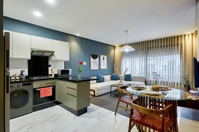 a kitchen and a living room with a table at Charming 1 Bed Casablanca Retreat With Free Parking in Casablanca