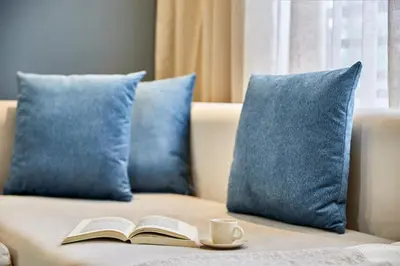 a book and a cup of coffee on a couch with pillows at Charming 1 Bed Casablanca Retreat With Free Parking in Casablanca