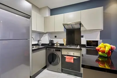 a kitchen with a refrigerator and a dishwasher at Charming 1 Bed Casablanca Retreat With Free Parking in Casablanca