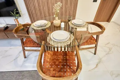 a glass table and chairs with plates on it at Charming 1 Bed Casablanca Retreat With Free Parking in Casablanca