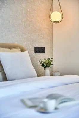 a bedroom with a bed and a vase with a plant at Sleek and Modern 2-Bed Unit in Downtown Casa in Casablanca