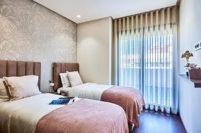 a hotel room with two beds and a window at Sleek and Modern 2-Bed Unit in Downtown Casa in Casablanca