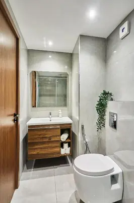 a bathroom with a toilet and a sink at Sleek and Modern 2-Bed Unit in Downtown Casa in Casablanca