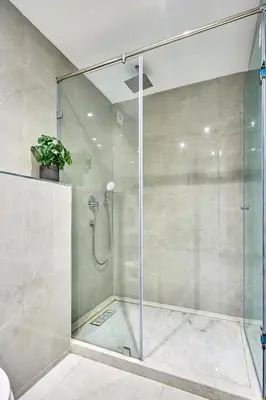 a shower with a glass door in a bathroom at Sleek and Modern 2-Bed Unit in Downtown Casa in Casablanca