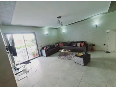 a living room with a couch and a table at Marbella Beach Almansouria in Mansouria