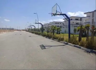 an empty street with a basketball hoop on it at Marbella Beach Almansouria in Mansouria