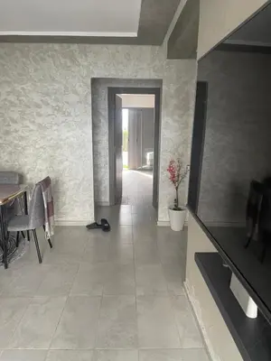 a living room with a table and a tile floor at Marbella Beach Almansouria in Mansouria
